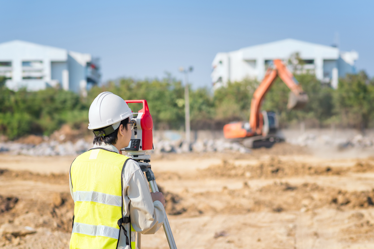 Construction engineer use surveyor equipment checking constructi